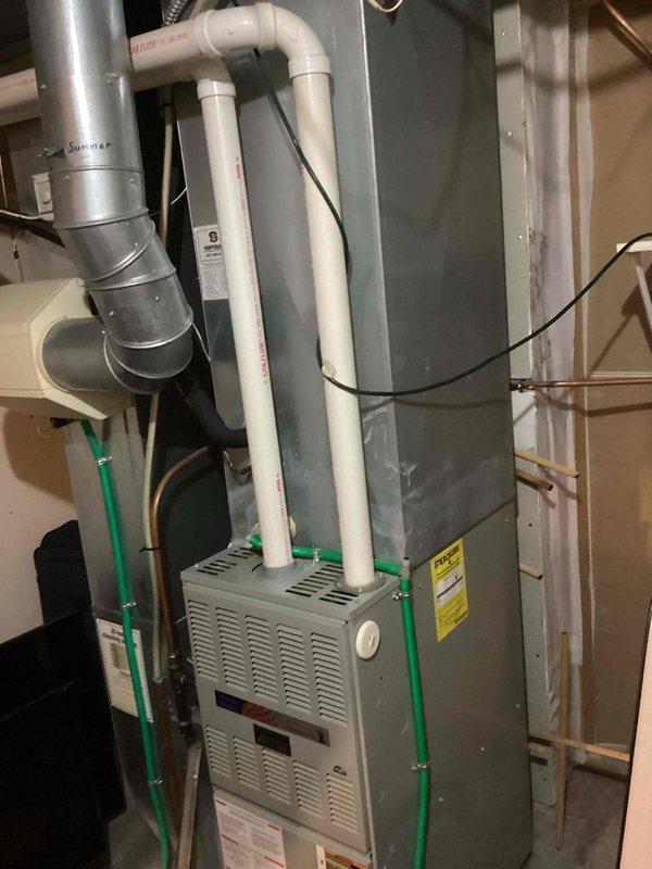 Responded to no heat call for residential furnace. Inspection revealed failed heat exchanger on existing unit. Documented condition with photos showing the furnace installation with proper PVC venting and condensate lines. Advised client on repair vs. replacement options based on age and condition of equipment.