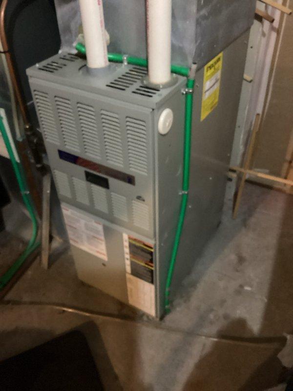 Responded to no heat call for residential furnace. Inspection revealed failed heat exchanger on existing unit. Documented condition with photos showing the furnace installation with proper PVC venting and condensate lines. Advised client on repair vs. replacement options based on age and condition of equipment.