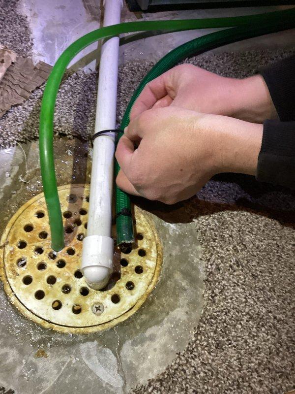 Responded to urgent call for water leakage from furnace. Relocated humidifier drain line to floor drain and secured with zip ties to prevent further leakage. Replaced batteries in outdoor temperature sensor and installed new furnace filter to restore proper system functionality.