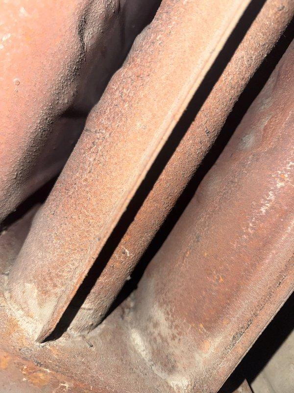 Responded to no-heat call for 1982 Trane furnace making noise on shutdown. Inspection revealed severely corroded heat exchanger with visible cracks and burned molex connection for blower motor. Unit was red-tagged due to safety hazards and recommended preventative maintenance for replacement.