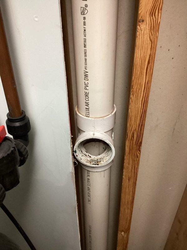 Responded to a service call for toilet drain leak affecting basement laundry room. Diagnosed a cracked 3" clean out fitting at the hub on the main stack, which was leaking when drain was in use. Replaced the damaged section by cutting out the compromised clean out fitting and PVC pipe, then installed new clean out and pipe sections. Verified repair by testing toilet flush, confirming proper function with no leaks.