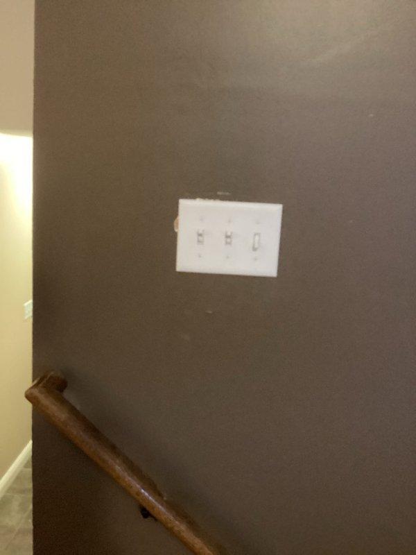 Installed a 3-wire circuit from existing 2-gang switch box to the center of the living room between railing and exterior wall. Added a switch for customer-provided ceiling fan and replaced old kitchen light fixture with new customer-provided unit. Completed installation of triple-switch panel in stairwell area with proper mounting and connections.