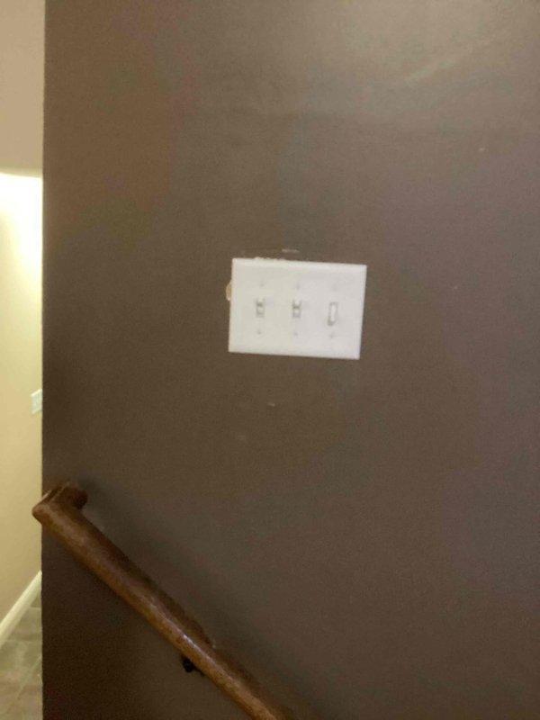 Installed a 3-wire circuit from existing 2-gang switch box to the center of the living room between railing and exterior wall. Added a switch for customer-provided ceiling fan and replaced old kitchen light fixture with new customer-provided unit. Completed installation of triple-switch panel in stairwell area with proper mounting and connections.