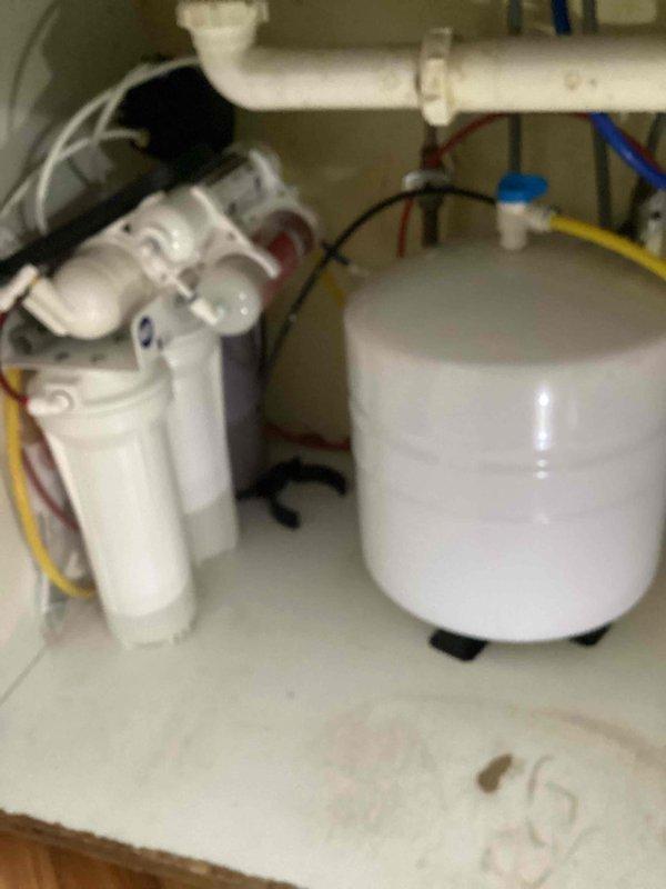 Diagnosed low water pressure issue with customer's iSpring RO system. Inspection revealed resin from the alkaline filter had been released into supply lines, causing significant flow restriction. Advised customer to contact manufacturer regarding warranty coverage for the system.