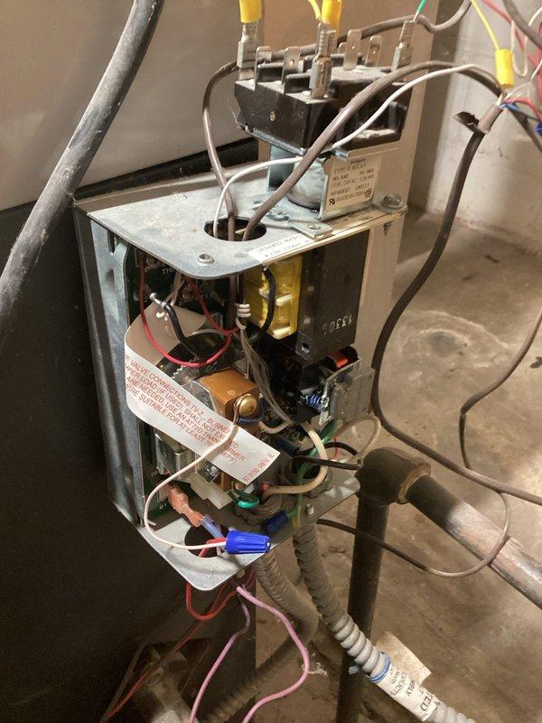 Performed post-repair inspection of boiler system, confirming proper operation. Examined electrical control panel components including transformer, terminal connections, and wiring harnesses to verify correct electrical function. Documented system with photos showing control box assembly and internal electrical components for service record.