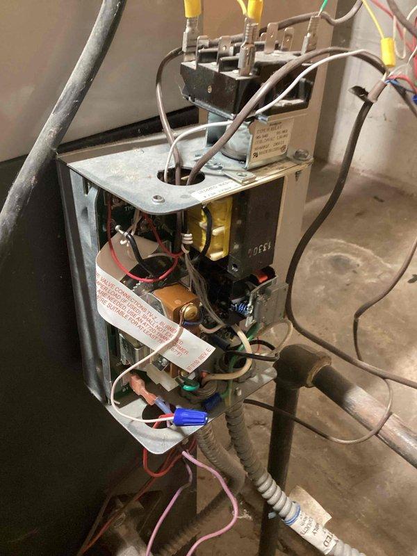 Performed post-repair inspection of boiler system, confirming proper operation. Examined electrical control panel components including transformer, terminal connections, and wiring harnesses to verify correct electrical function. Documented system with photos showing control box assembly and internal electrical components for service record.