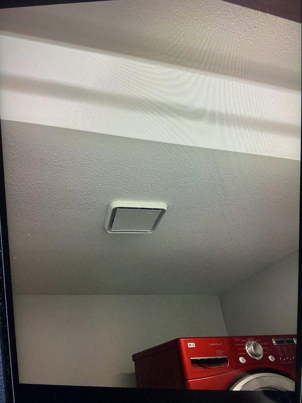 Responded to service call regarding bathroom fan dripping water in laundry room. Upon inspection, found ventilation fan heavily coated with dust and debris. System was tested for proper operation; unable to recreate dripping issue. Determined probable cause was vent becoming temporarily stuck during cold weather conditions.