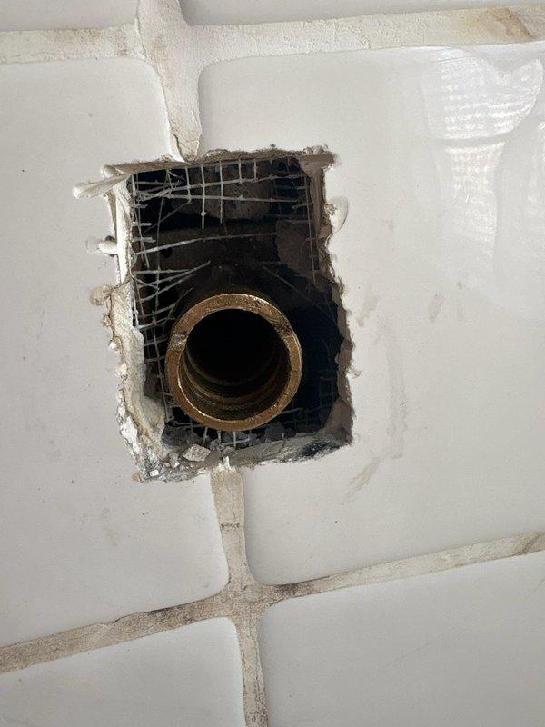 Performed inspection of faulty Moen shower valve with water shut off to the valve only. Documented damage to surrounding tile and access point. Provided estimate for complete shower valve replacement including installation of proper access panel.