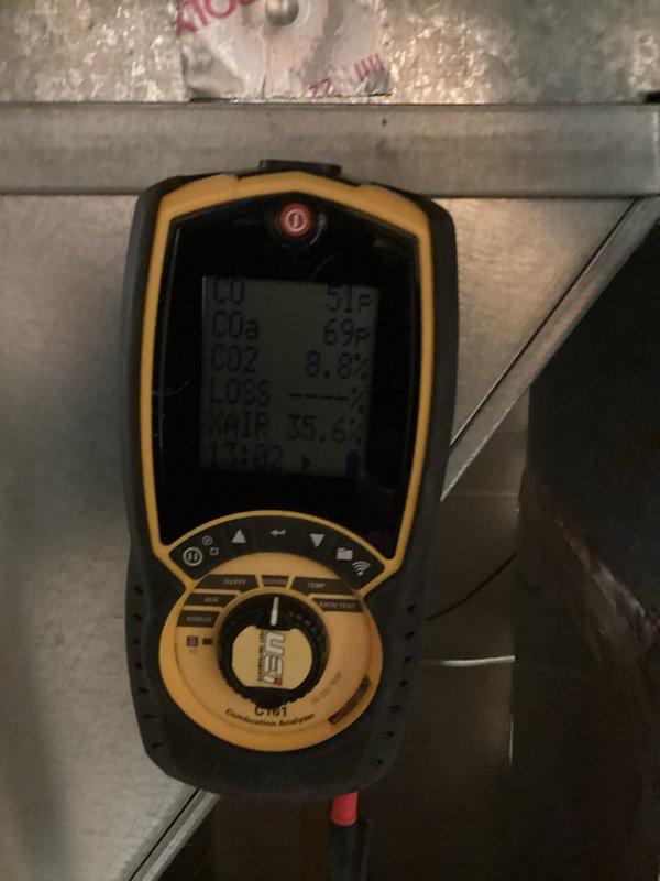 Replaced defective collector box under warranty on heat exchanger. Performed combustion analysis with UEi C161 analyzer to verify proper system operation after repair. Observed normal condensation patterns on metal base panel indicating unit is functioning correctly post-installation.