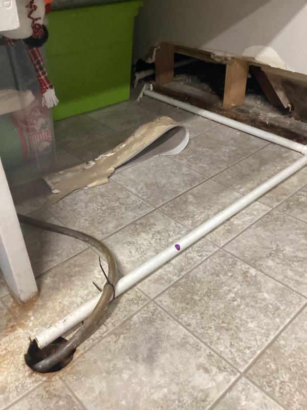 Responded to service call regarding humidifier leak. Confirmed customer's report that drain line had disconnected from PVC pipe behind furnace. Documented condition with photos showing exposed plumbing and affected area. Issue escalated to management for resolution per warranty protocol.