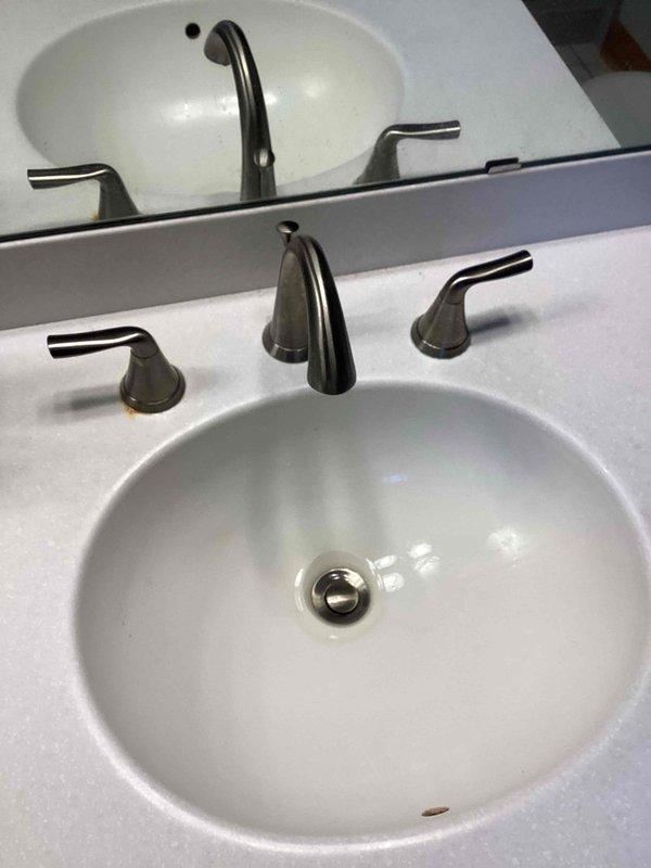 Serviced two widespread lavatory faucets with frozen hot handles due to defective hot side cartridges. Successfully freed handles through repeated opening and closing operations, restoring functionality. Provided customer with estimate for replacement of both faucets with new brushed nickel widespread models.