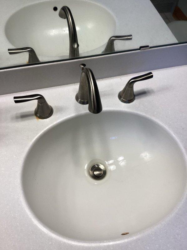 Serviced two widespread lavatory faucets with frozen hot handles due to defective hot side cartridges. Successfully freed handles through repeated opening and closing operations, restoring functionality. Provided customer with estimate for replacement of both faucets with new brushed nickel widespread models.
