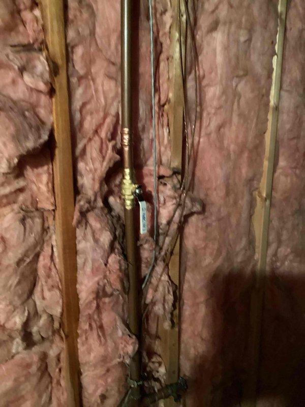 Responded to leak in basement and discovered pin hole leak on 1" copper mainline. Removed damaged section of copper pipe, replaced with new copper section, and installed a new 1" ball valve on the mainline to provide proper shut-off capability after the water meter.