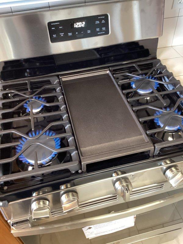 Arrived within scheduled window to disconnect old gas range and install new gas appliance. Successfully installed new gas line, connected to customer's range, and verified proper operation by testing all burners. Documented installation with photos showing completed hookup and operational burners with proper flame pattern.