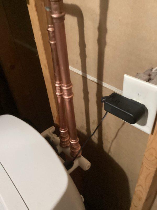 Responded to emergency water leak call in mechanical room affecting adjacent bedroom carpet. Diagnosed issue as leaking bypass valve on water softener system. Removed defective bypass valve and installed new replacement valve. Successfully restored water service with no further leakage observed. Documented repair with photos showing copper pipe installation and connections.