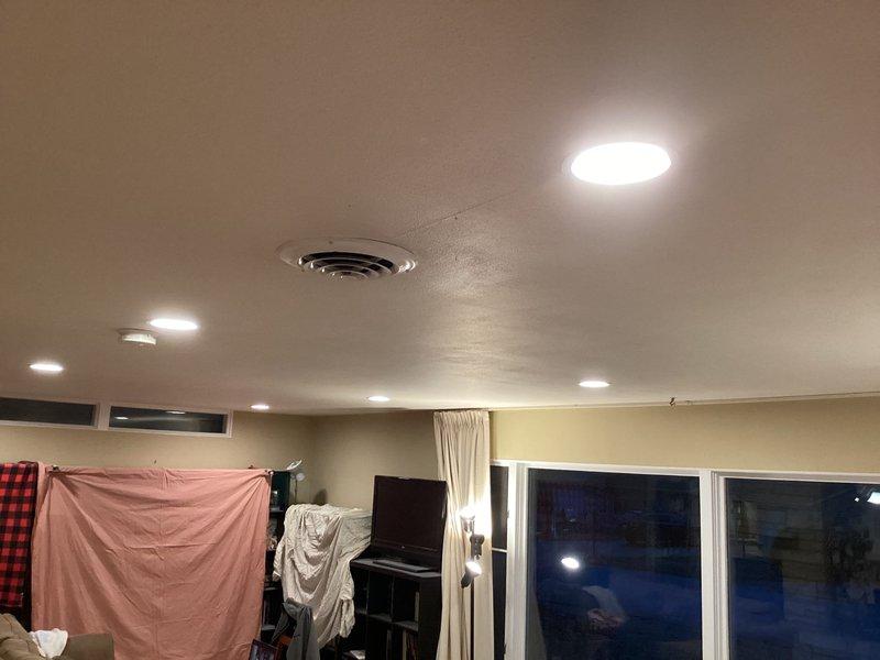 Successfully installed 8 recessed can lights with barreled trim and bulbs in the living room, replacing the existing low voltage solenoid control system with a new dimmer switch. Verified proper functionality of all outlets in the area after installation was complete.