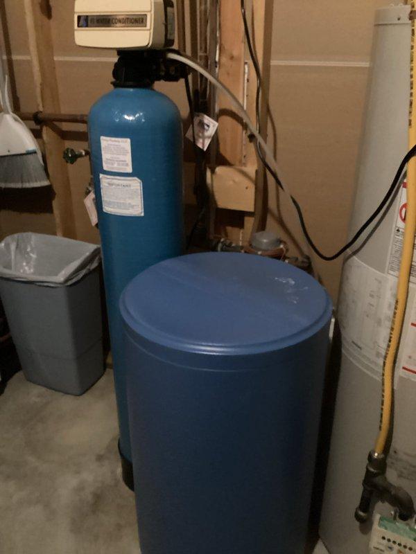 Arrived during scheduled window for water softener estimate. Assessed existing water treatment system consisting of a dual-tank setup (blue cylindrical softener unit and taller filtration/conditioner tank) with accompanying piping and connections. Provided comprehensive estimate for recommended two-piece water treatment solution based on evaluation of current equipment and household needs.
