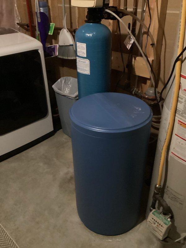 Arrived during scheduled window for water softener estimate. Assessed existing water treatment system consisting of a dual-tank setup (blue cylindrical softener unit and taller filtration/conditioner tank) with accompanying piping and connections. Provided comprehensive estimate for recommended two-piece water treatment solution based on evaluation of current equipment and household needs.