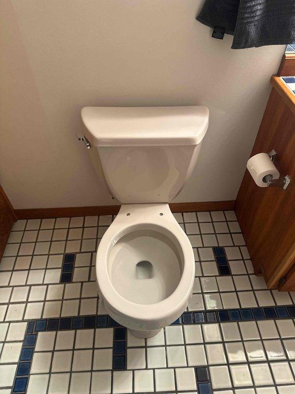 Diagnosed and repaired toilet leaking at base by replacing damaged wax ring seal. Completed installation of new wax seal to restore proper function and eliminate leakage from base of toilet.