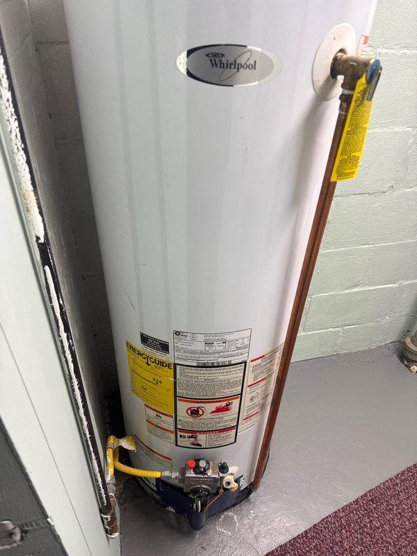 Responded to service call for basement water leak. Located and repaired pinhole leak in 1/2" copper fitting by replacing affected section of pipe. Inspected water heater and surrounding plumbing connections to ensure no additional leaks were present.