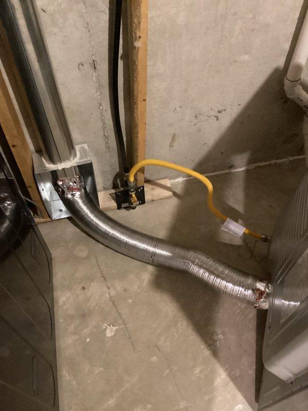 Returned to property to complete gas dryer installation by properly connecting the exhaust ductwork. Installed flexible aluminum ducting from dryer outlet to wall vent, ensuring secure connections at both ends. Verified proper gas line connection and tested system for proper operation before completing service call.
