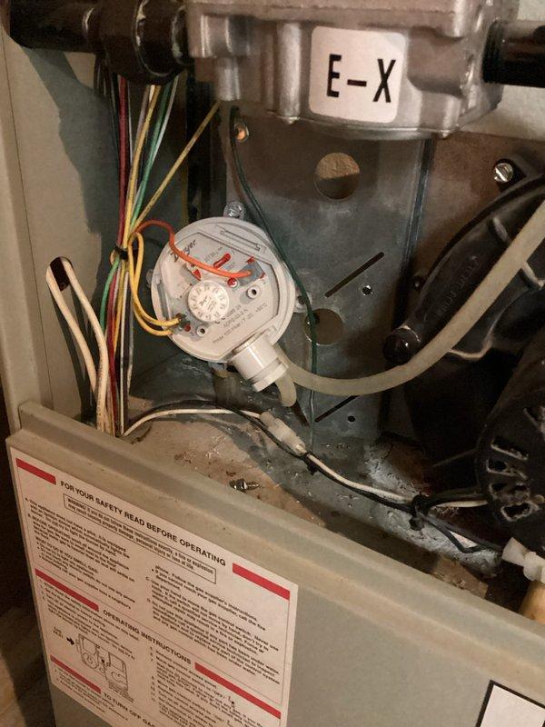 Responded to no heat complaint following previous service call. Diagnosed pressure switch wired incorrectly with reversed connections. Corrected wiring configuration and properly repositioned pressure switch hoses, restoring normal furnace operation.