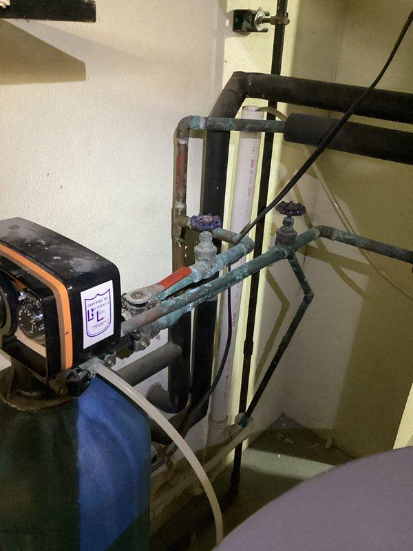 Conducted an on-site estimate for replacement of existing water heater and water softener system. Inspected current installation, noting the JCS Plumbing-branded water softener with electronic control head and associated plumbing connections. Documented the condition of the existing equipment, including visible oxidation on some copper pipes, and prepared comprehensive replacement options. Quote for both units was emailed to customer with membership and non-membership pricing options as requested.