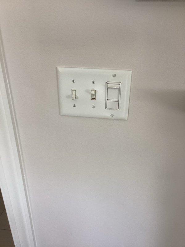 Relocated three outlets to accommodate TV installation and electric fireplace positioning. Replaced faulty dimmer switch in dining room with new compatible unit. Tested all modified circuits to verify proper operation and safe installation according to electrical code requirements.