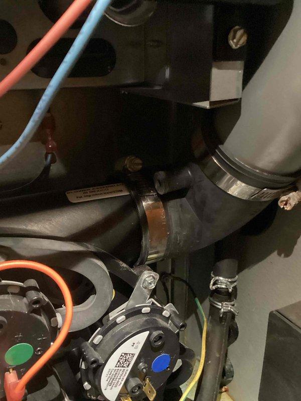 Responded to callback regarding water accumulation at the bottom of furnace. Upon inspection, identified loose clamp on inducer boot as the source of the leak. Performed repair by properly tightening the clamp, resolving the water issue.