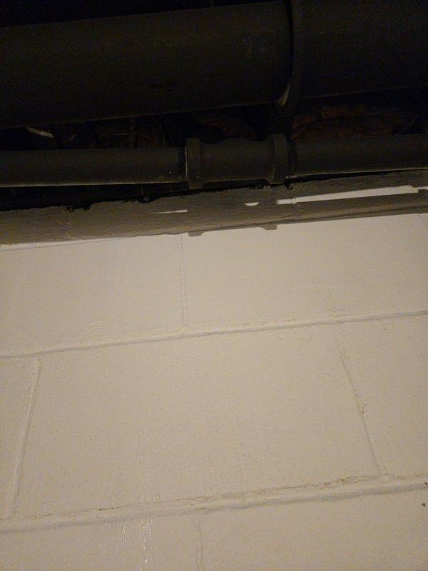 Responded to emergency service call for water intrusion in basement. Upon inspection, identified kitchen faucet as source of leak, which was determined to be non-repairable. Assessed plumbing configuration and provided estimate for installation of customer-supplied replacement faucet, including removal of existing garbage disposal and installation of straight drain piping.