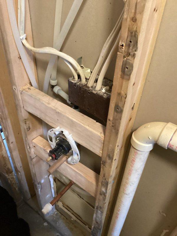 Conducted site assessment for shower valve relocation project. Inspected existing plumbing configuration within exposed wall framing, including PVC drainage pipes and water supply lines. Prepared estimate for moving shower valve to higher position on existing pipe and installing appropriate drainage for new tile shower installation.