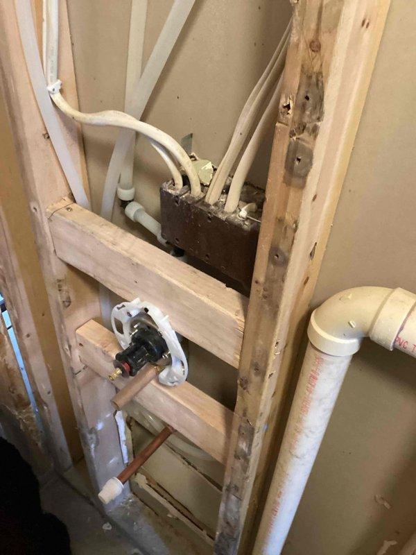 Conducted site assessment for shower valve relocation project. Inspected existing plumbing configuration within exposed wall framing, including PVC drainage pipes and water supply lines. Prepared estimate for moving shower valve to higher position on existing pipe and installing appropriate drainage for new tile shower installation.