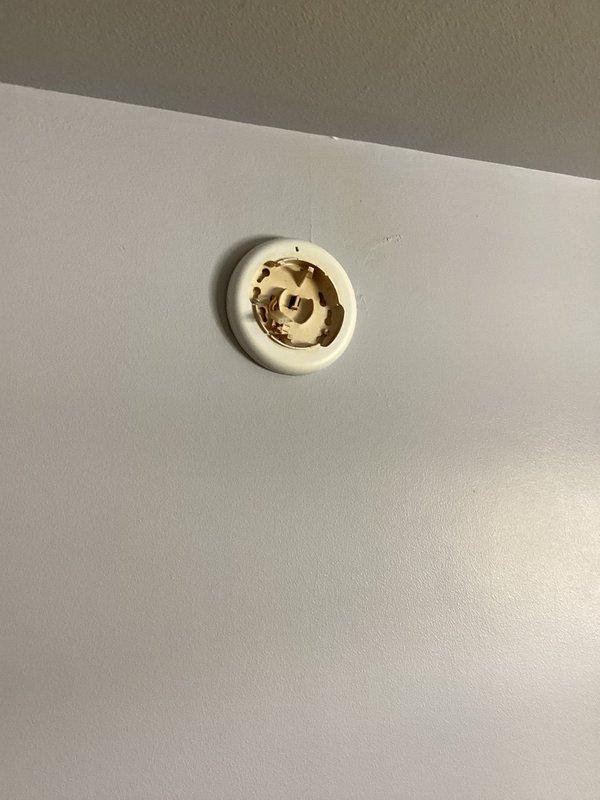 Arrived within scheduled window and replaced two 20+ year old hard-wired smoke detectors with new units. Observed damaged wall fixture with cracked plastic cover and exposed interior components. Will return to install additional smoke/CO detector in hallway as requested.