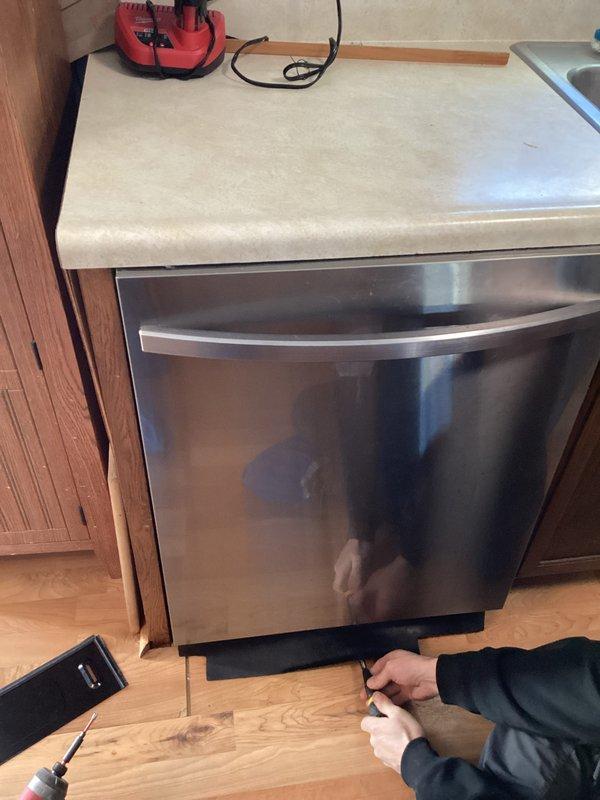 Disconnected and reconnected dishwasher to facilitate diagnostic procedures. Identified and corrected wiring issues, successfully restoring dishwasher functionality. Documented repair with photos of the electrical panel and under-counter installation area.