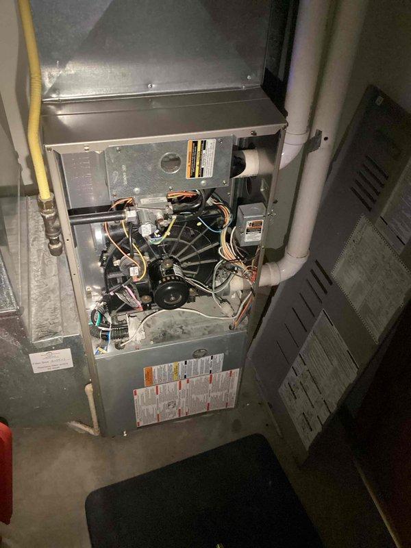 Completed prepaid maintenance service on residential furnace system. Inspected internal components including blower motor, fan blade, electrical wiring, and control boards. Examined ventilation system including connected PVC pipes, with particular attention to the pipe section with repair tape.