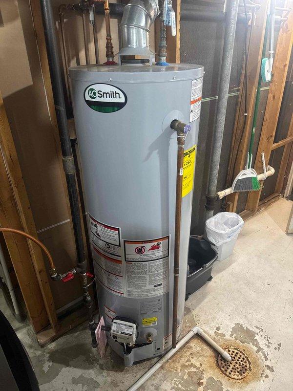Responded to service call for A.O. Smith water heater with leaking gas valve. Upon inspection, confirmed gas leak at valve connection requiring replacement. Unit was red tagged by MN Energy due to safety concerns. Will schedule return visit to replace valve, considering unit age and repair cost assessment.