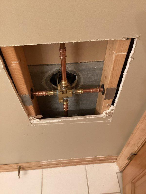Responded to a call back for a leaking shower valve. Accessed the valve through the downstairs bathroom ceiling, removed the 20-year-old American Standard fixture (for which replacement parts were unavailable due to age), and installed customer-provided Delta shower valve. Made all necessary connections, restored water service, and verified proper operation.