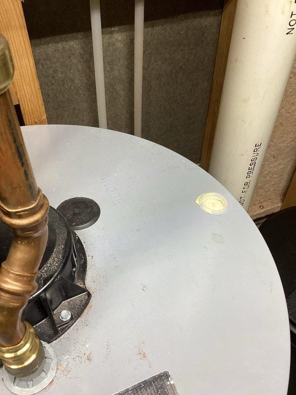 Responded to service call for water heater issues where customer reported purple water and leaking temperature and pressure relief valve. Diagnosed 40-gallon AO Smith water heater with compromised anode rod causing discolored water. Provided customer with estimate for replacement of T&P valve and anode rod to resolve both the leakage and water quality issues.