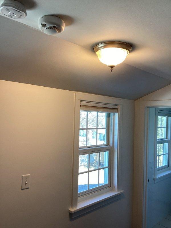 Completed installation of customer-provided light fixture and multiple electrical upgrades including: new white dimmer switch, replacement of hallway wafer light, installation of new LED trim for existing can light, and installation of LED-compatible dimmer in main floor bathroom to resolve light flickering issues. All switches were installed in white finish and all lighting was confirmed to be 2700K color temperature.