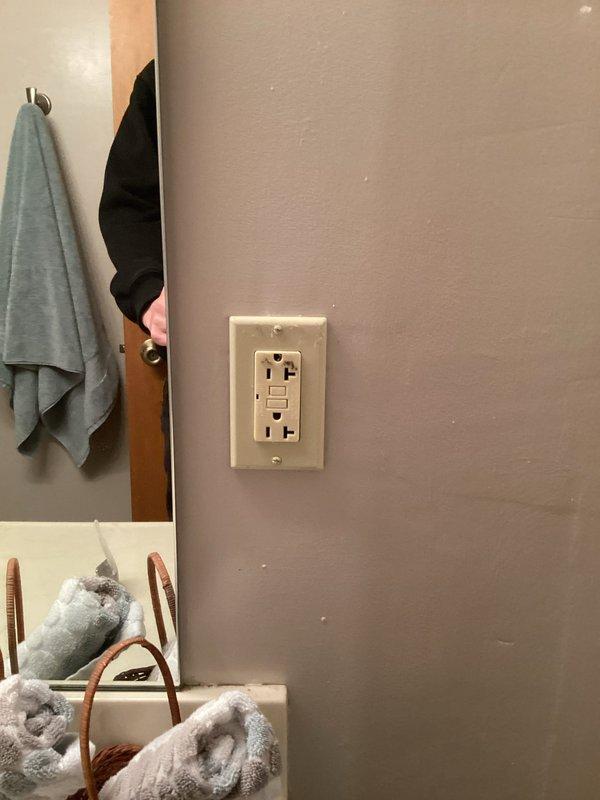 # Electrical Service - Inspection Summary

Completed FRM (Final Residential Mechanical) electrical inspection at residential property. Identified two code compliance issues requiring correction: absence of GFCI protection at clothes washer receptacle in utility room and defective GFCI outlet in main floor bathroom requiring replacement. Documented deficiencies with photographic evidence showing existing bathroom GFCI outlet and overall property conditions. Provided detailed estimates to homeowner for necessary corrections to meet electrical code requirements and pass final inspection.