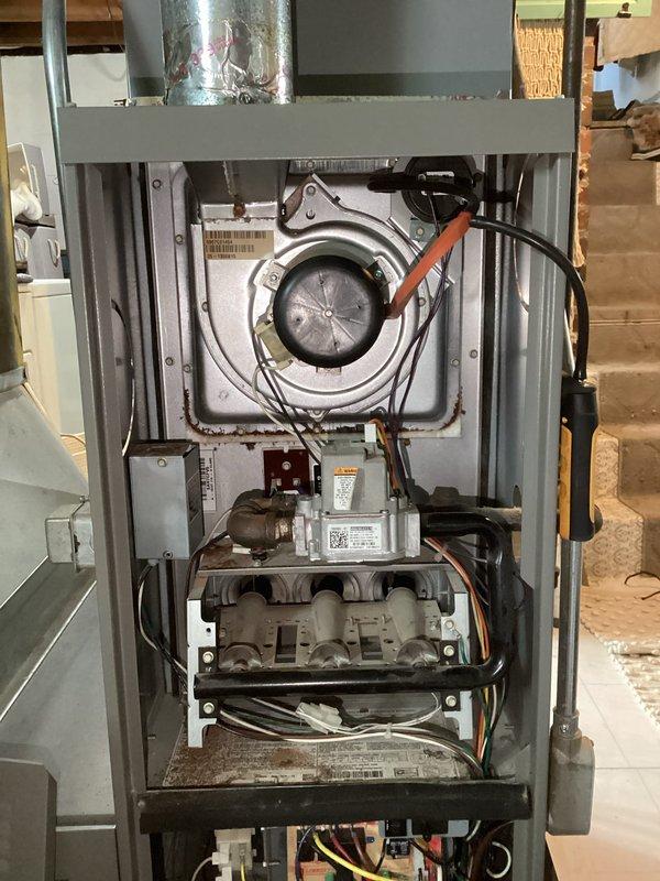 # Service Report: No Heat Call - Control Board Failure

Responded to a no-heat service call on a residential furnace system less than 10 years old. Upon arrival, performed diagnostic evaluation to determine cause of heating failure. Initial assessment indicated potential igniter malfunction; however, further testing revealed failed control board as the root cause of system inoperability.

Removed access panel and inspected internal electrical components and control circuitry. Verified control board failure through visual inspection and electrical testing. The main circuit board showed signs of component failure preventing proper system operation and ignition sequence. All wire connections, gas valve assembly, inducer motor, and associated safety controls were inspected during diagnostic process.

Documented equipment condition through photographs showing control board assembly, wiring connections, and internal furnace components including inducer blower assembly and gas manifold. Prese