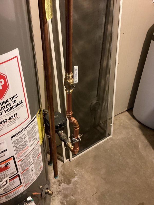 Completed installation of customer-supplied toilet and new water softener system in basement utility area. Repaired water leak at main meter with new copper piping connections and fittings. All plumbing connections were properly secured with brass valves and metal brackets to ensure system integrity. Water softener unit was installed with appropriate inlet and outlet piping, electrical connection established, and system tested for proper operation. Leak repair at main meter required replacement of deteriorated sections and installation of new shut-off valves for future maintenance access.