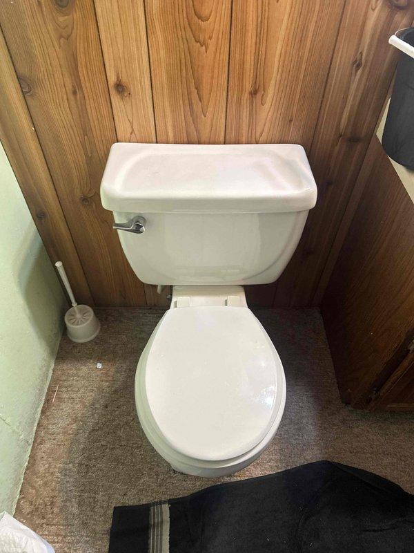 Responded to service call for toilet with missing internal tank components. Upon arrival, found flush handle broken and internal flush mechanism parts absent from tank. Replaced defective flush handle with new chrome lever assembly to restore proper flushing operation.