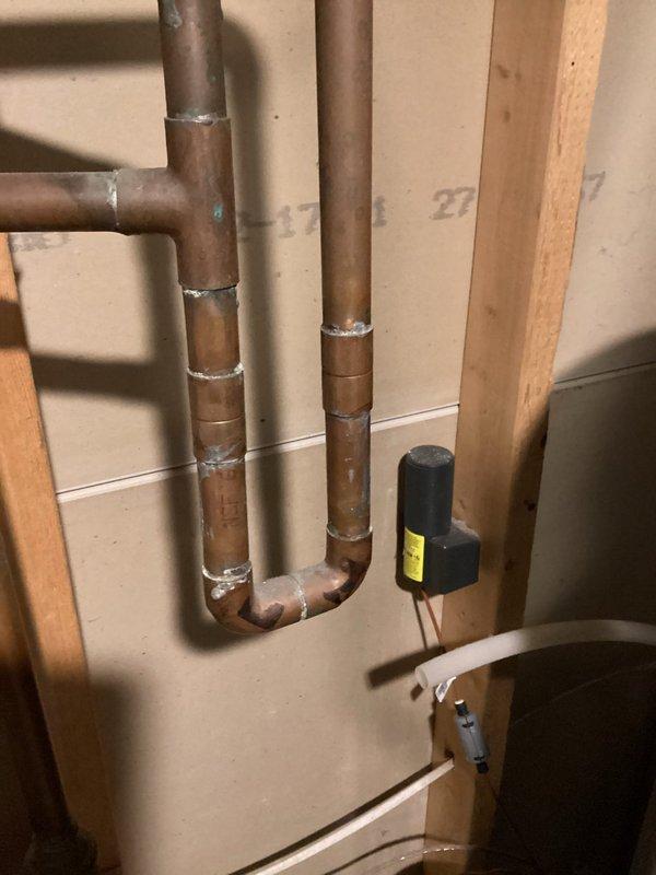 Arrived on-site within scheduled 8-12 window and conducted assessment of existing copper plumbing infrastructure for installation of customer-supplied water softener unit. Evaluated current pipe configuration, including vertical runs and U-bend sections with soldered joints, to determine optimal integration point for the softening system. Provided detailed estimate for complete installation of the customer-supplied water treatment equipment, including necessary connections, bypass valve configuration, drain line routing, and electrical requirements for the control valve system observed in the existing plumbing setup.
