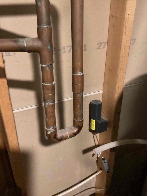 Arrived on-site within scheduled 8-12 window and conducted assessment of existing copper plumbing infrastructure for installation of customer-supplied water softener unit. Evaluated current pipe configuration, including vertical runs and U-bend sections with soldered joints, to determine optimal integration point for the softening system. Provided detailed estimate for complete installation of the customer-supplied water treatment equipment, including necessary connections, bypass valve configuration, drain line routing, and electrical requirements for the control valve system observed in the existing plumbing setup.