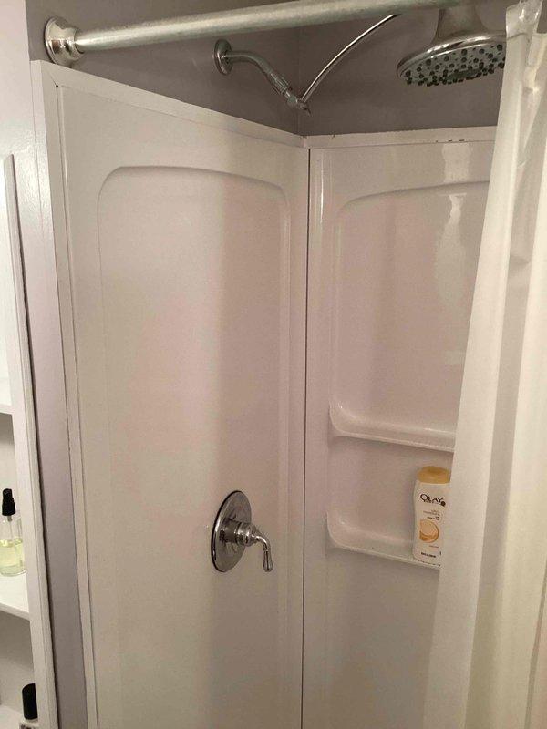 Completed comprehensive plumbing inspection of residential property, examining all fixtures, water heater, and drainage systems. Water heater and shower fixtures found to be in excellent working condition with proper operation confirmed. Identified active leak at kitchen faucet requiring replacement and provided estimate for new faucet installation.