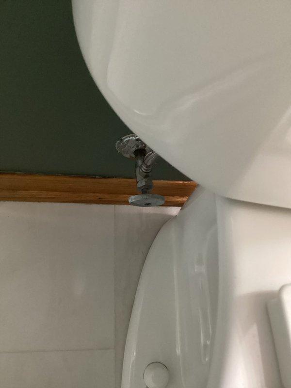 Completed comprehensive home plumbing inspection including evaluation of bathroom fixtures and water supply connections. Inspected bathroom sink with drop-in basin, chrome faucet assembly with dual handles, and angle stop valve with flexible supply line connection, documenting all visible plumbing components and fixture conditions with photographic records.