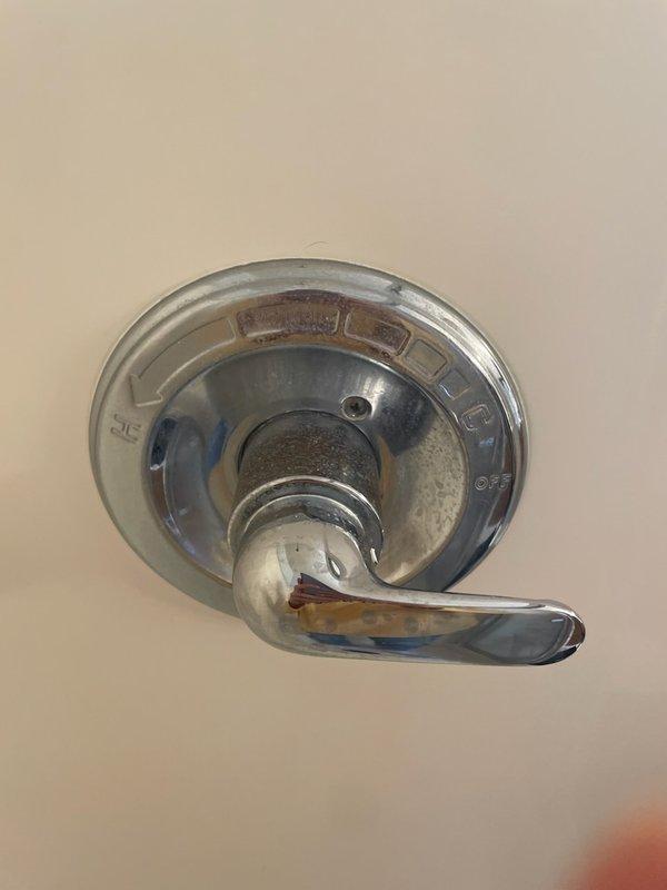 Responded to master bathroom shower issue where handle was falling off valve and shower head was spraying erratically during use. Upon inspection, found severe corrosion on both the shower handle and shower head, with significant mineral buildup and deterioration affecting proper operation. Removed corroded shower handle from valve assembly and replaced with new chrome fixture. Removed existing shower head displaying extensive mineral deposits and corrosion, then installed new replacement unit. Tested system operation to verify proper handle engagement with valve and confirmed shower head spray pattern functioned correctly without leakage.