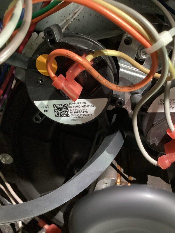 Responded to no heat call back on furnace system. Upon inspection, discovered water accumulation in pressure switch hose causing system failure. Replaced faulty pressure switch, verified proper operation with diagnostic testing showing -2.11" W.C. pressure reading, and installed rain gutter to prevent future water intrusion issues.