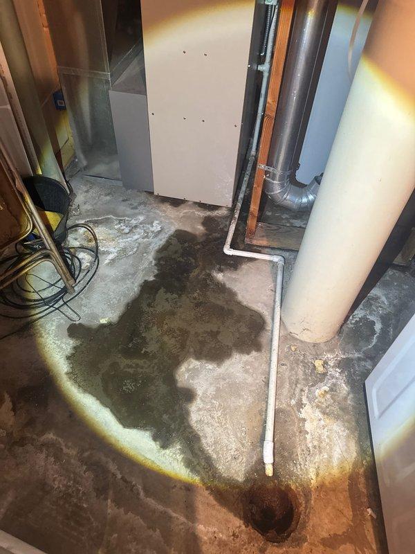 Responded to callback regarding lack of hot water following pressure valve replacement. Upon arrival, restored hot water functionality to the system. Identified improperly secured condensation line that was not glued at connection point, causing water discharge onto basement floor. Applied proper PVC cement to condensation line connections to ensure watertight seal and prevent future leakage. Documented existing water staining on concrete floor from condensation line issue.